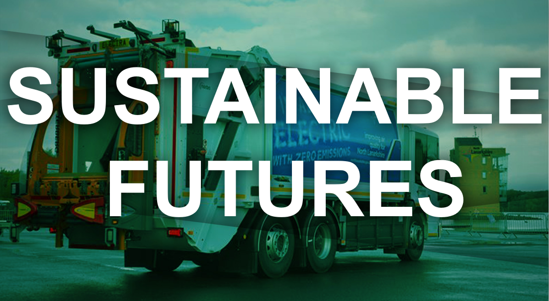 A large waste collection truck with a banner that reads "I'm all Electric with Zero Emissions" parked at Strathclyde Park under a cloudy sky.
