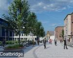 An image of a pedestrianised street showing people walking and cycling