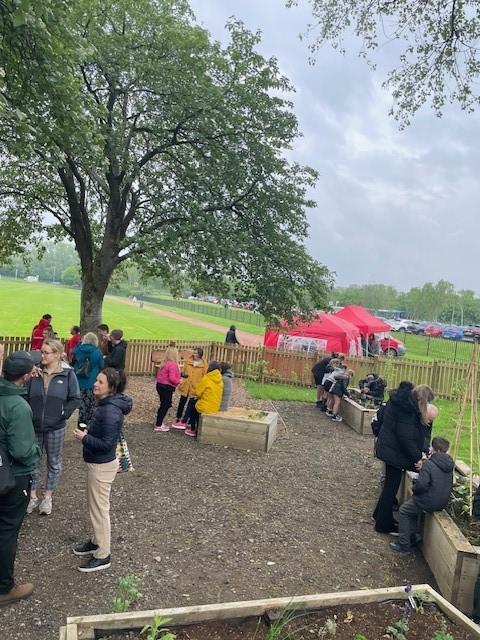 People looking round community garden