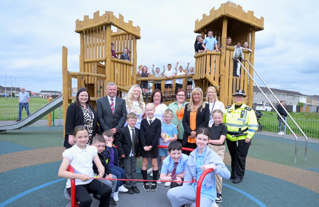 group of people in play area smiling during official opening