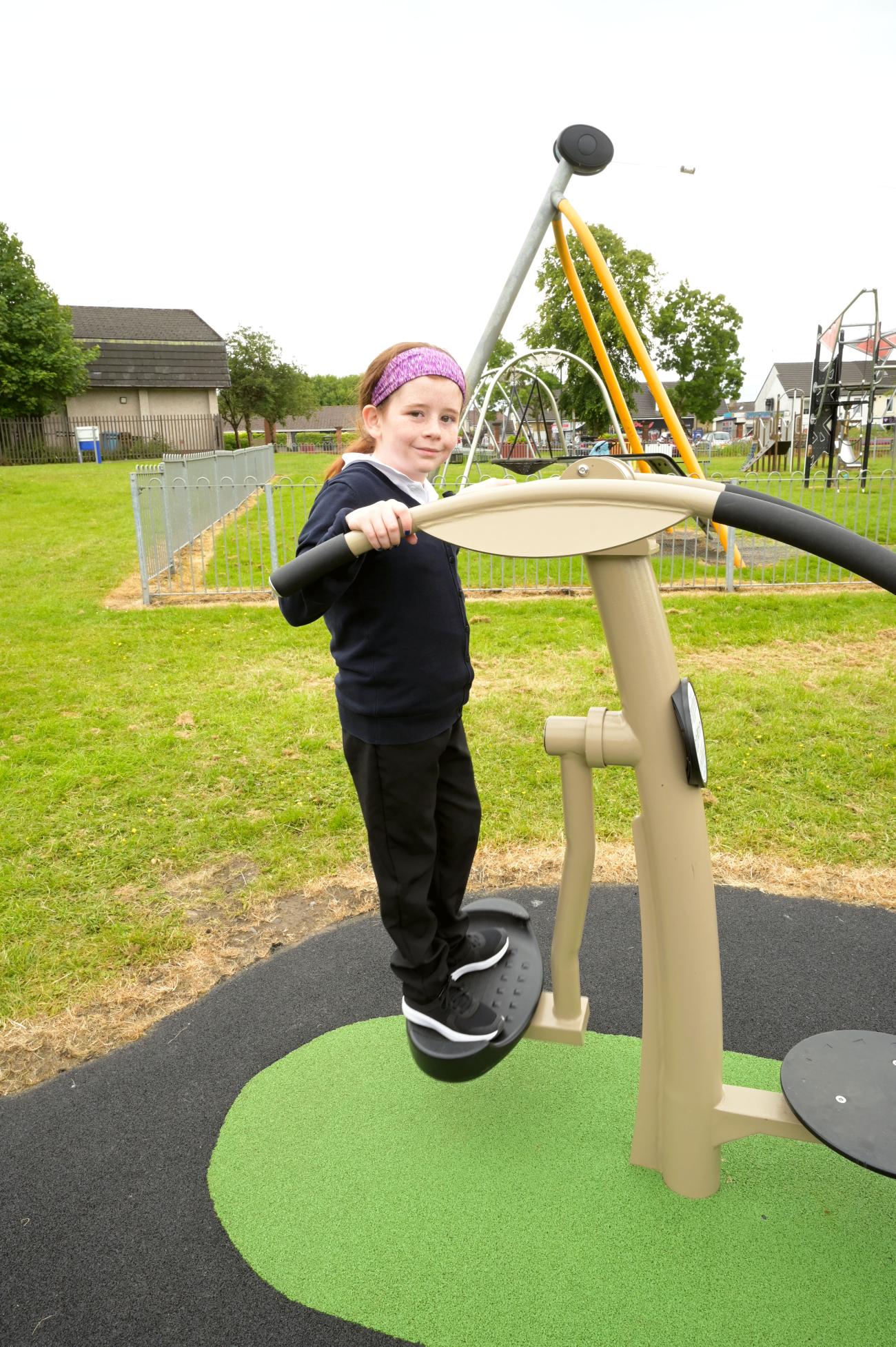 a child playing on outdoor gym equipment