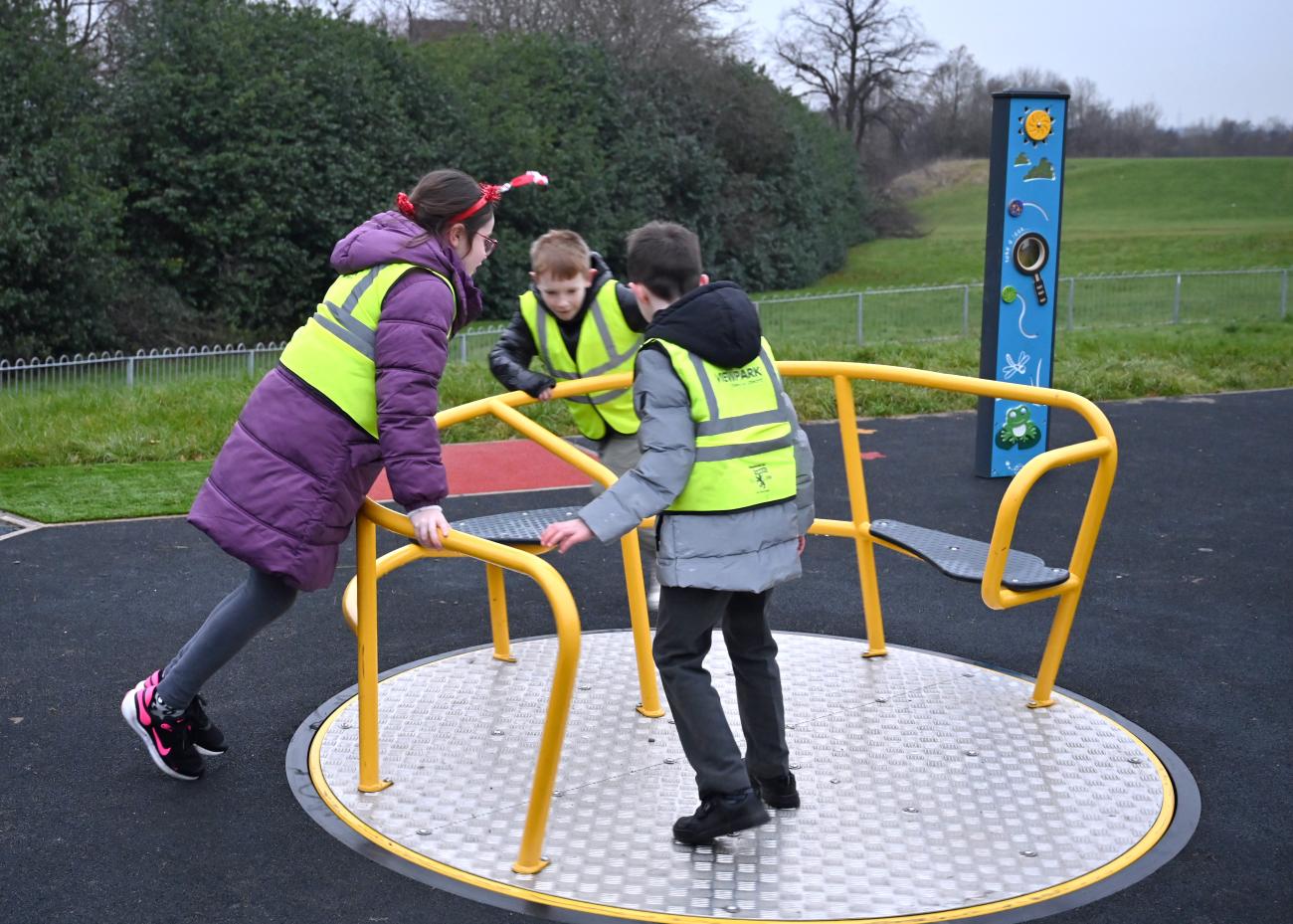 Children playing on merry go round