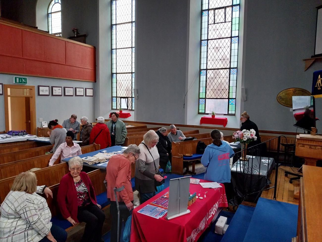 People gathered around tables socialising. 