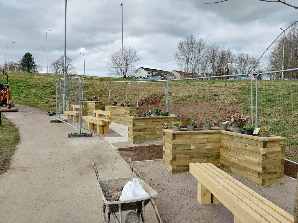 Community benches with in progress planting bedding. 