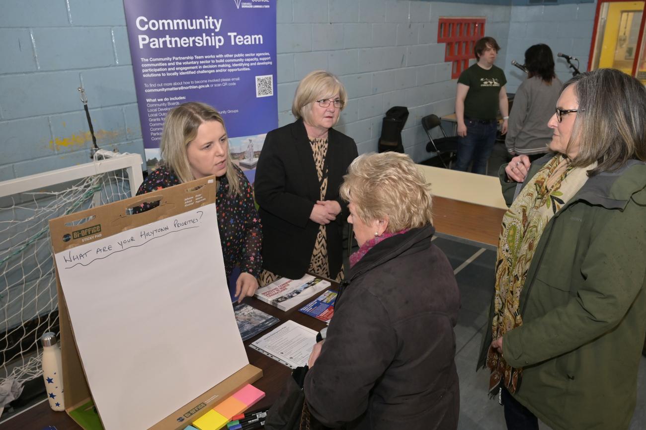Community members receiving information at a stall. 