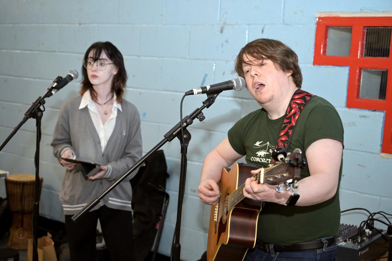 Two people performing live music. 