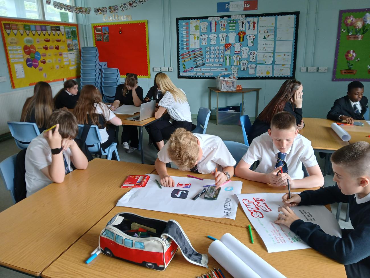 Students gathered around a table having a discussion 