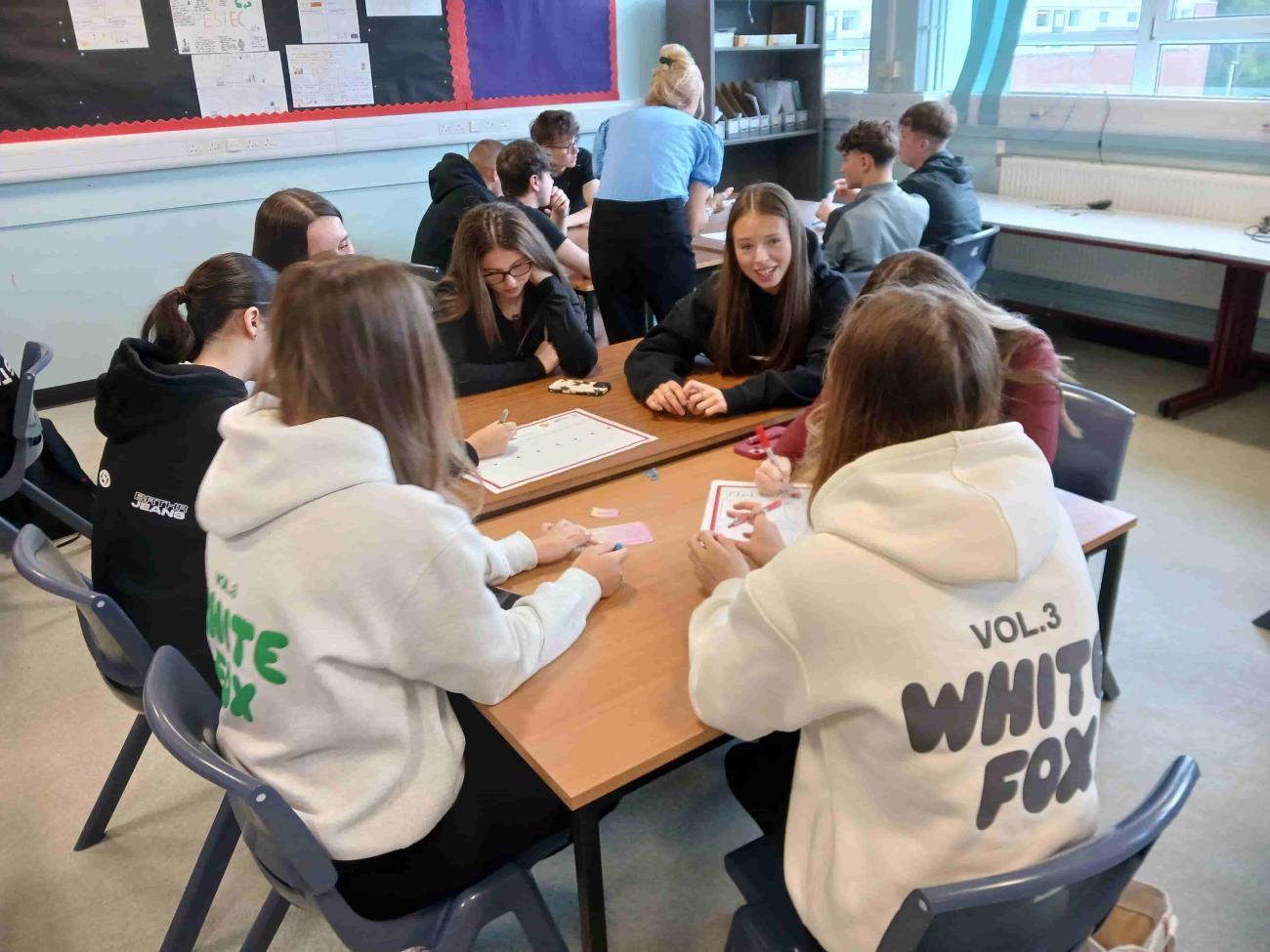 Pupils sitting around a table discussing ideas