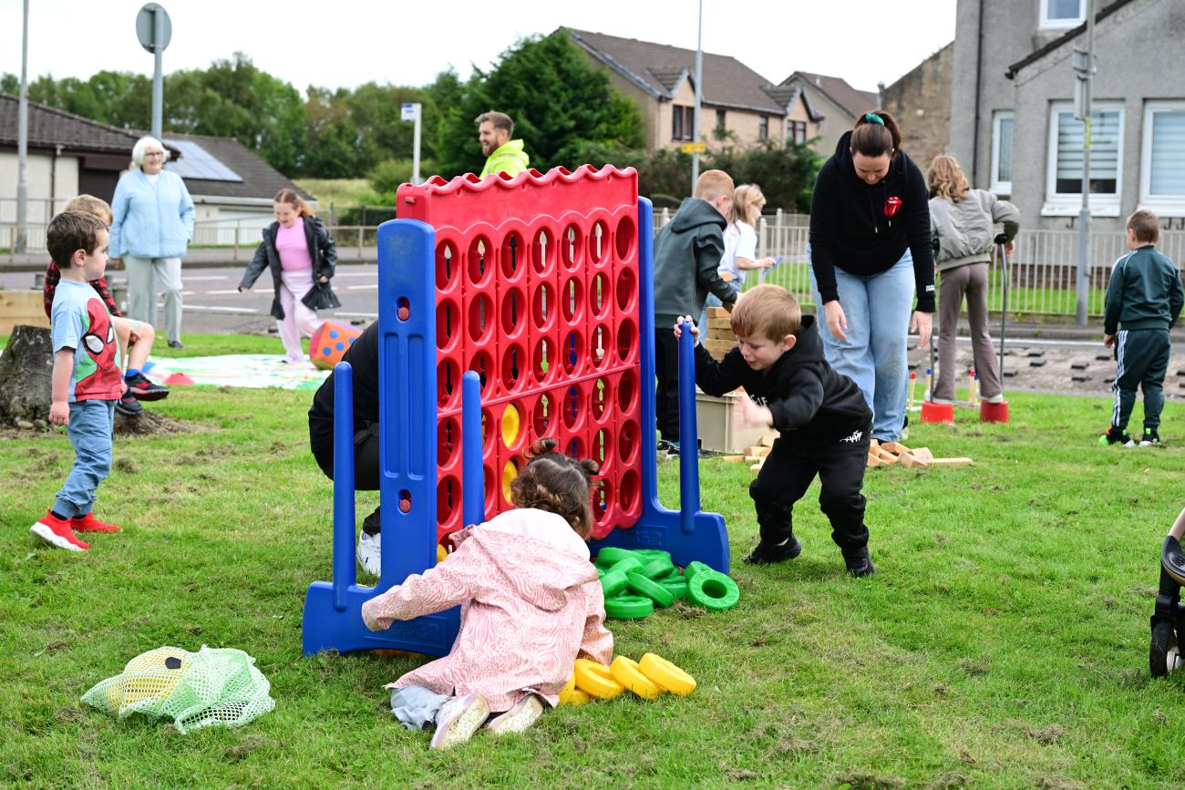 Children playing gardens - grass game of connect four