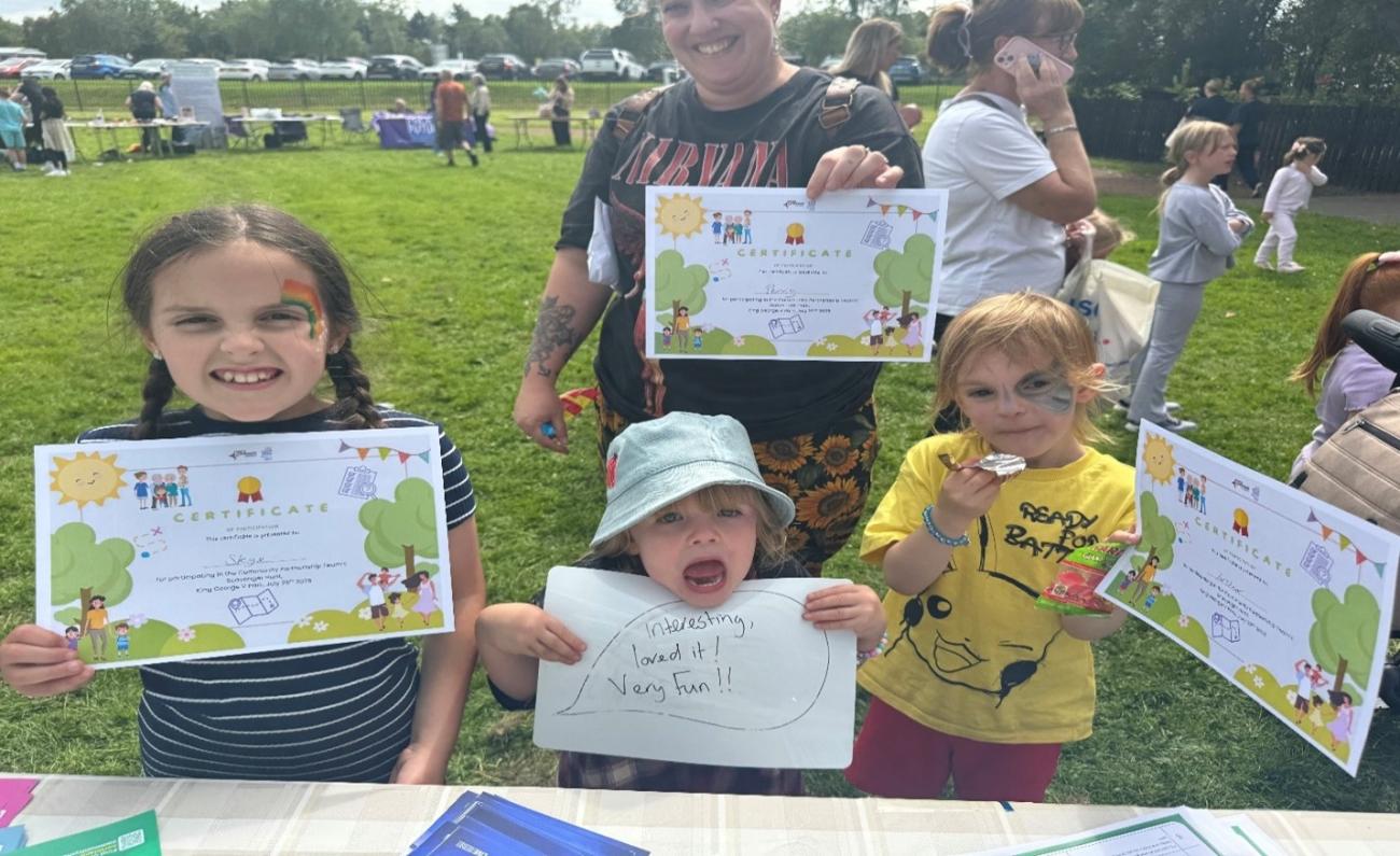 Children showing off their scavenger hunt checklist 