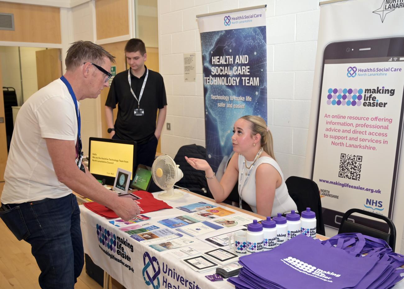 Member of community interacting with an information stall