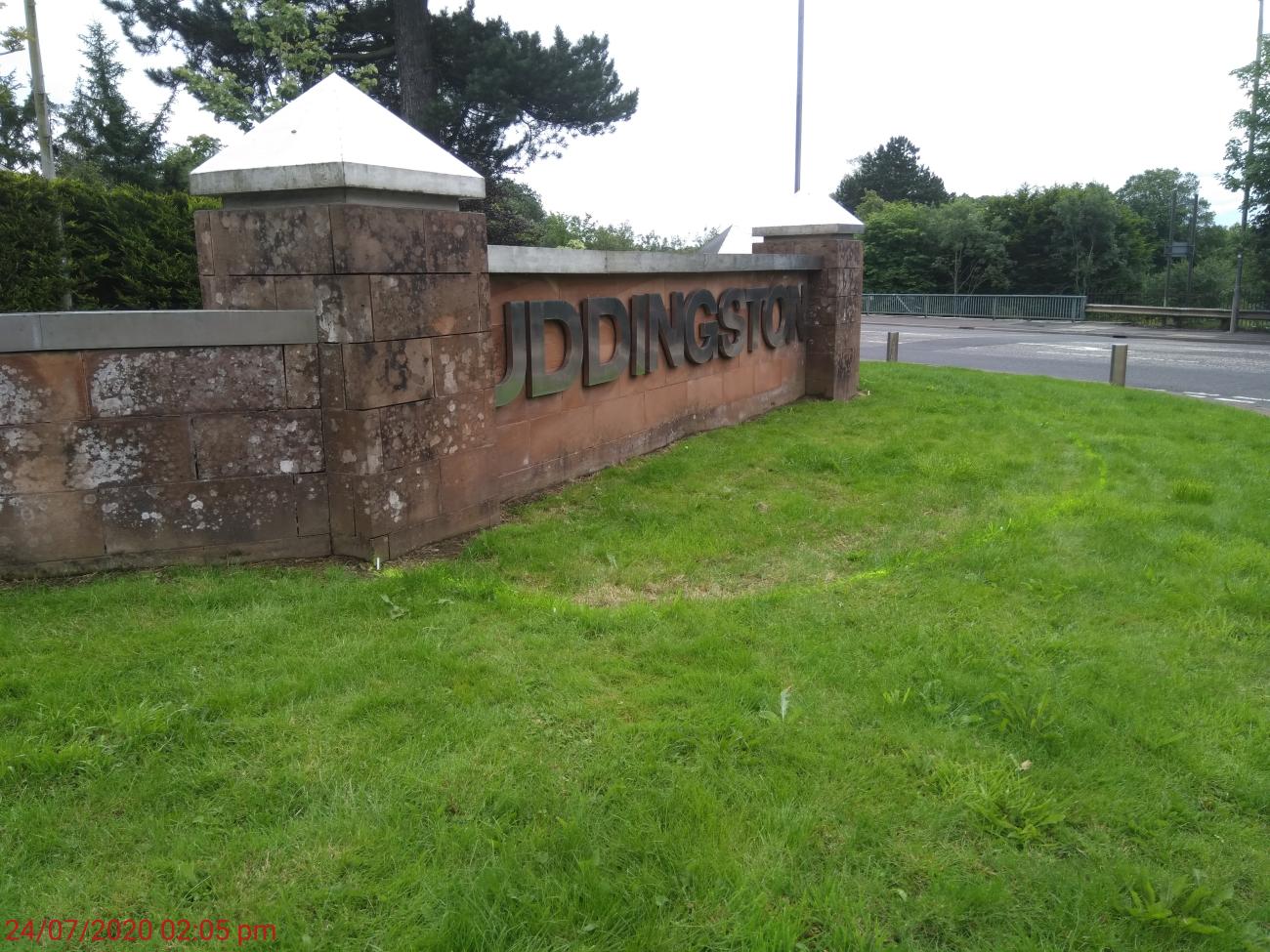 Uddingston Place wall with green grass 