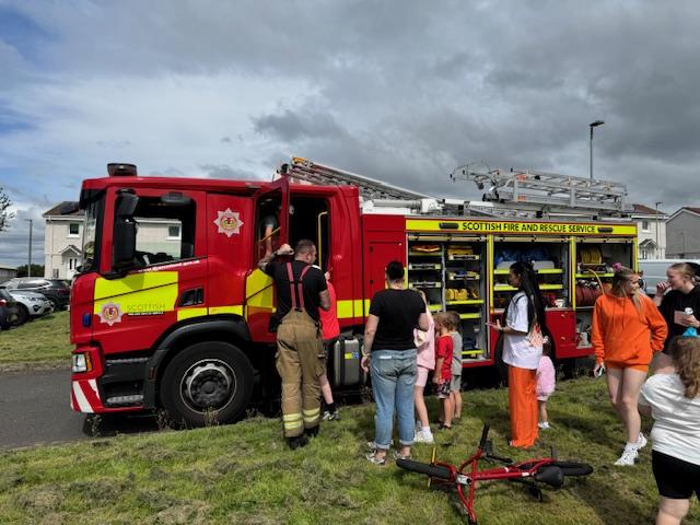 Community members interacting with Fire Fighters and Fire truck 