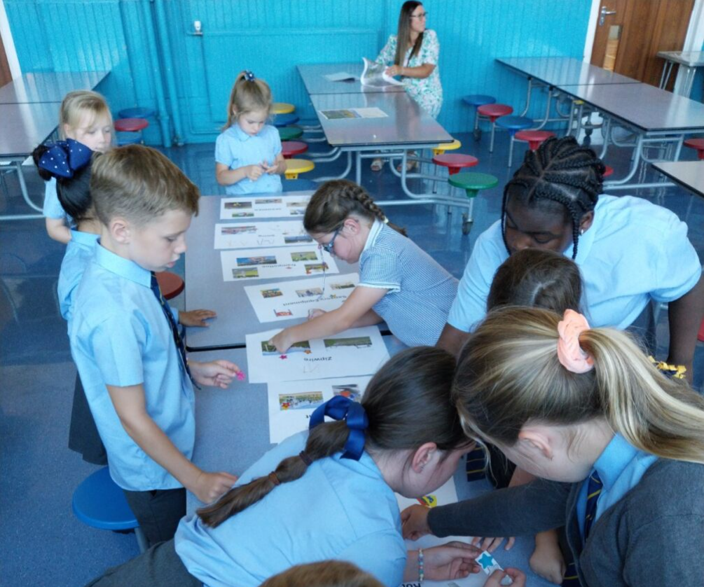 Children around a table picking ideas for a local play park 