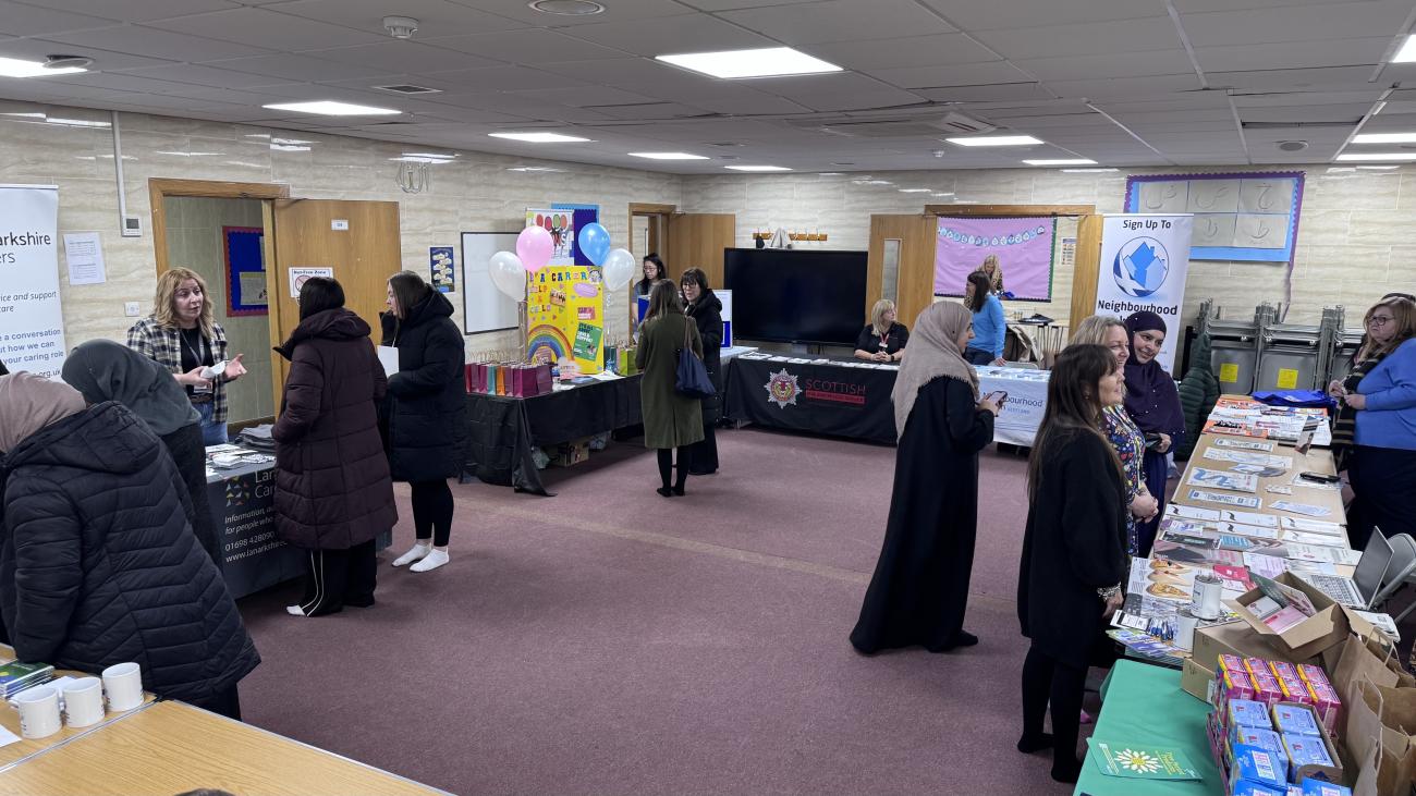Community members engaging with winter warmer stalls within a room 