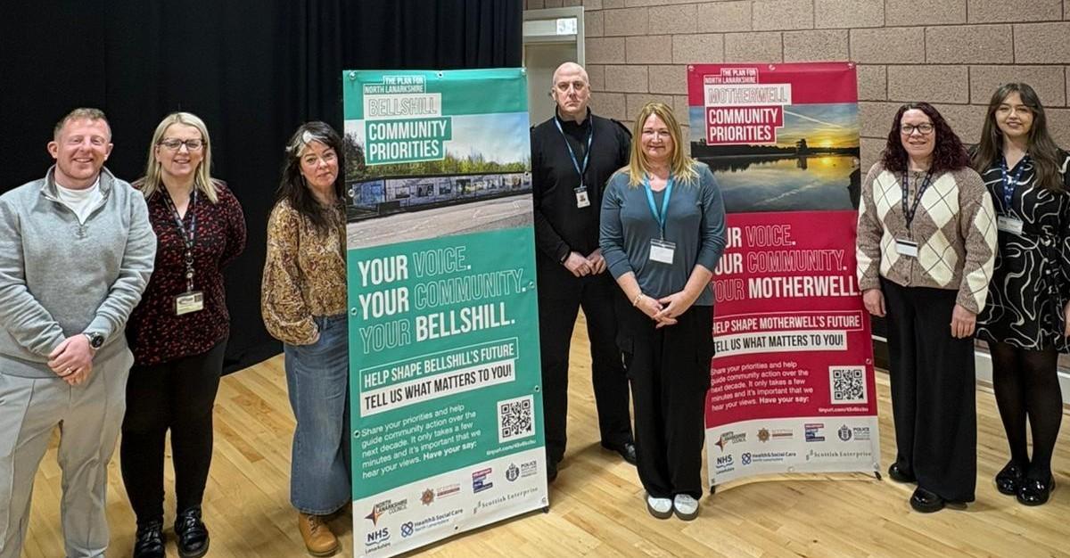 Community Partners standing beside pop up banners displaying Information 