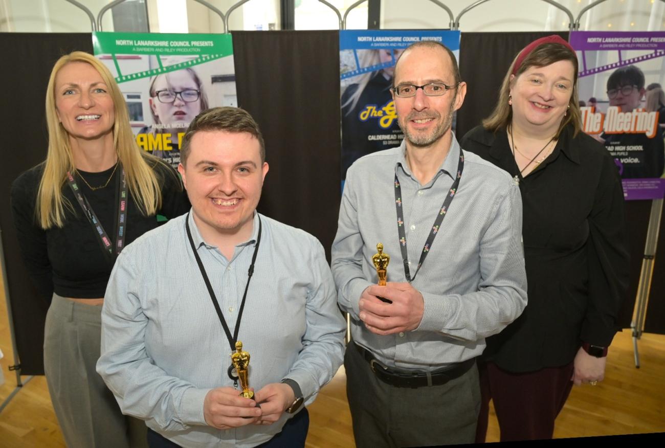 NLC Team Members standing for photo in front of banners