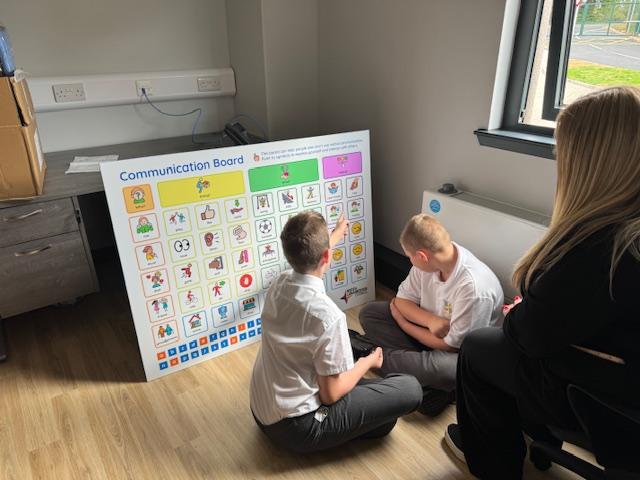 Pupils accessing and using the communication board