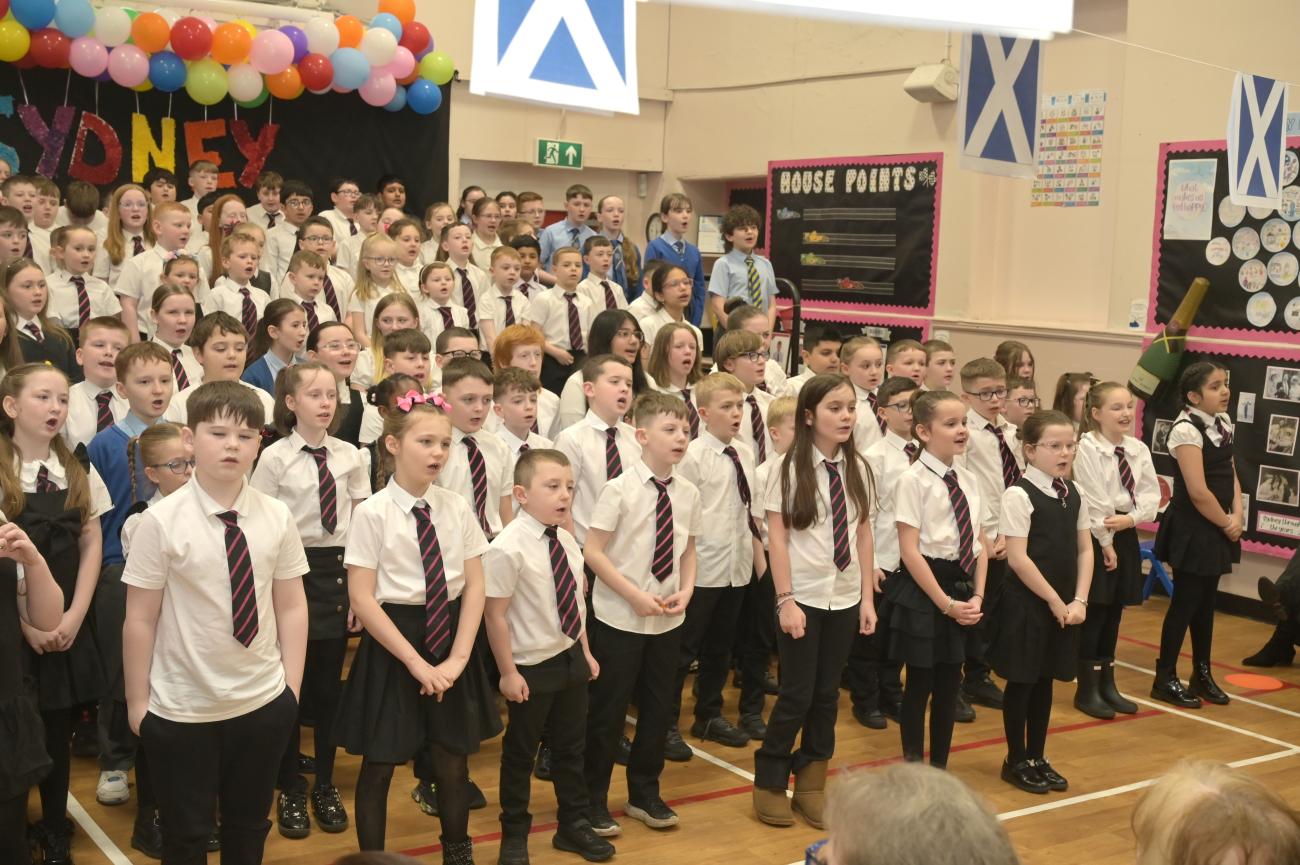 Pupils gathered singing in assembly hall