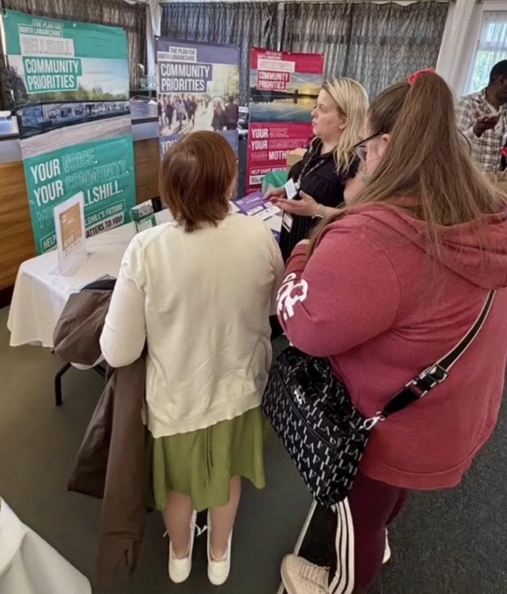 Community members standing at a stall engaging with council staff