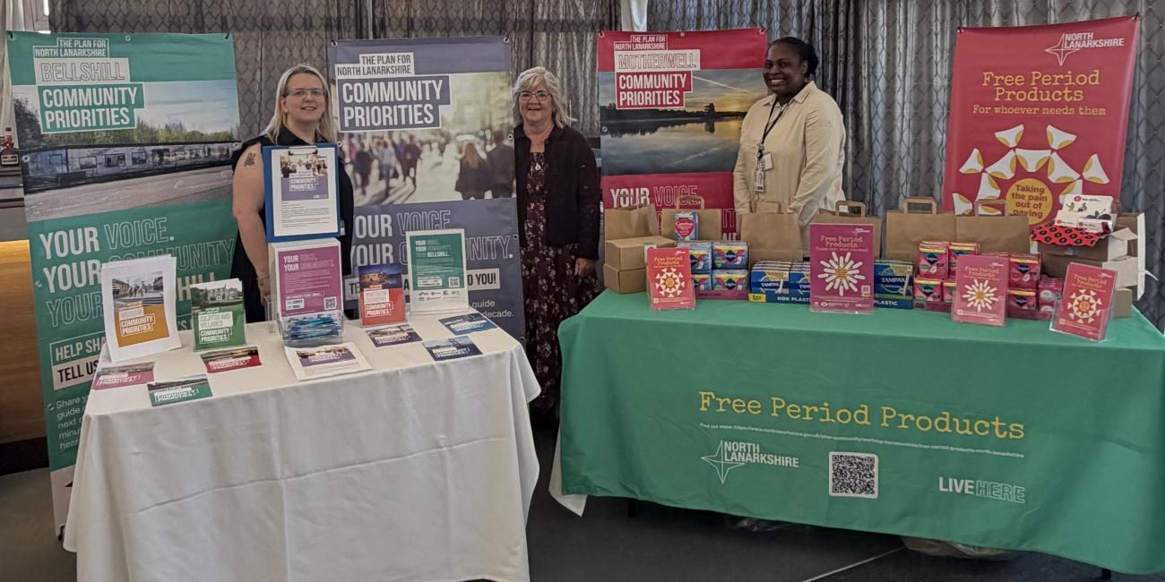 Image of a period dignity stall and community priorities stall with council staff present