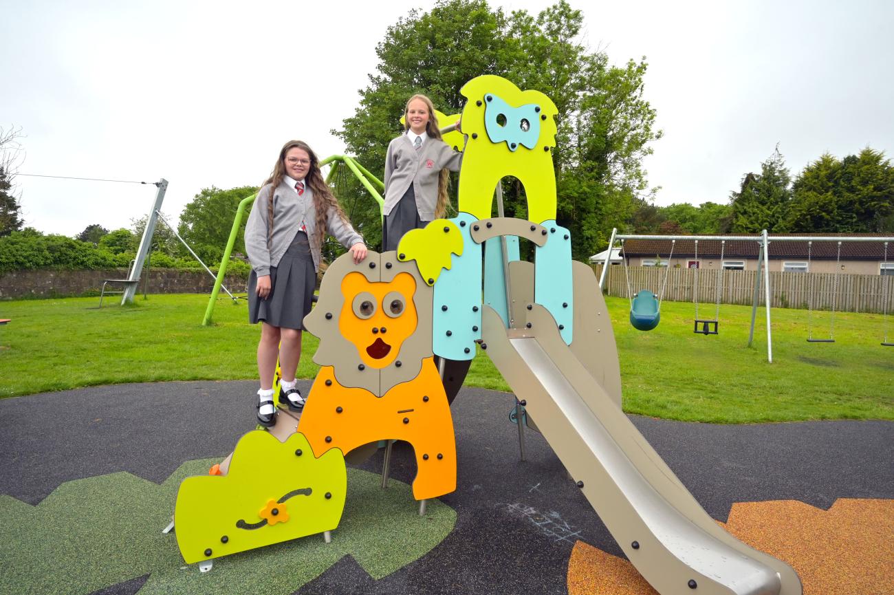 Two school pupils standing on the slide 