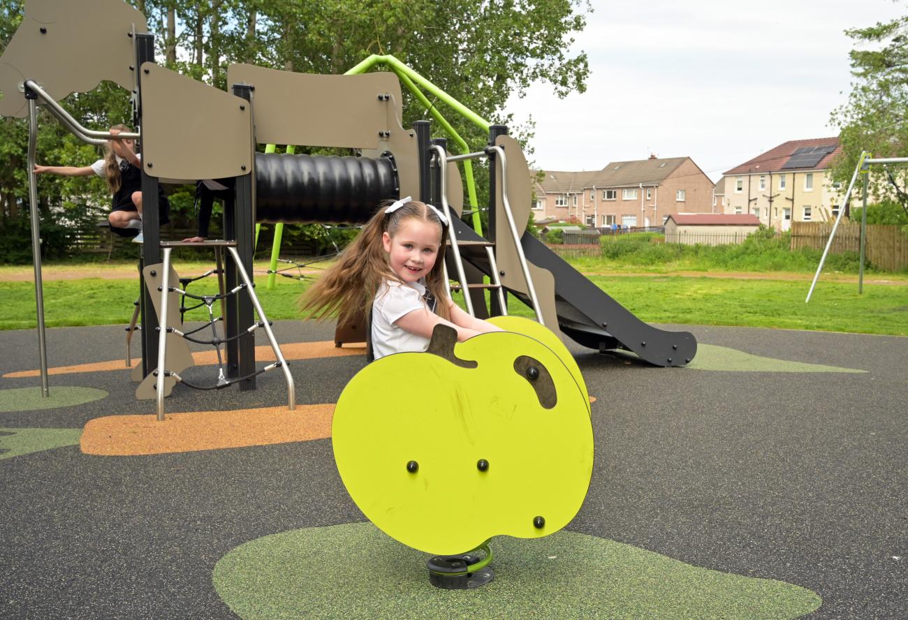 Pupil playing on new spring rider within Waverley Drive Park 