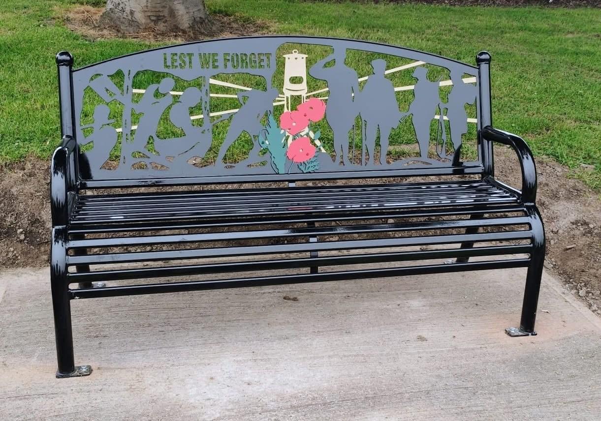 bench in park with war memorial images