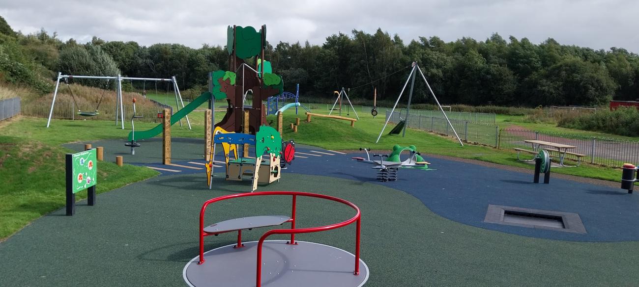 swings and multi use unit and play panels in new play area