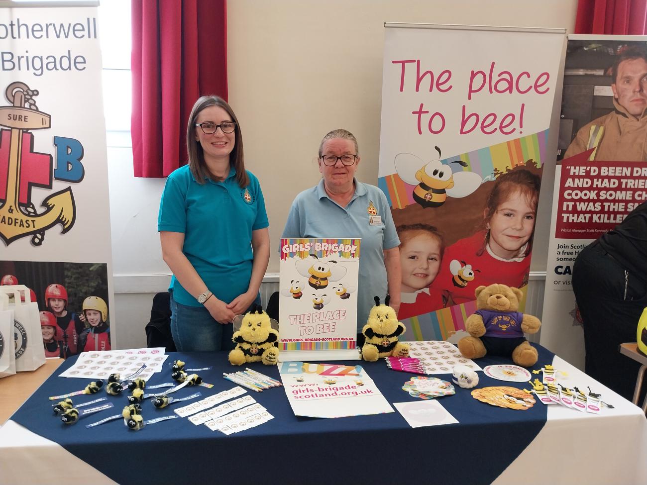 women standing around table with promotional materials