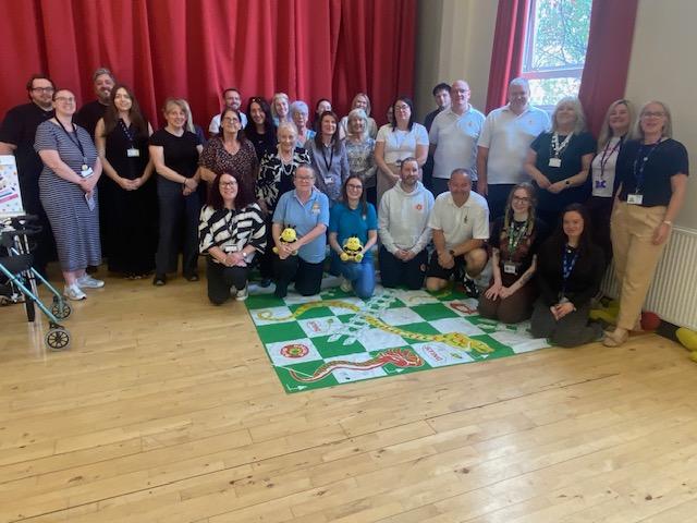Group photo of adults standing together in hall