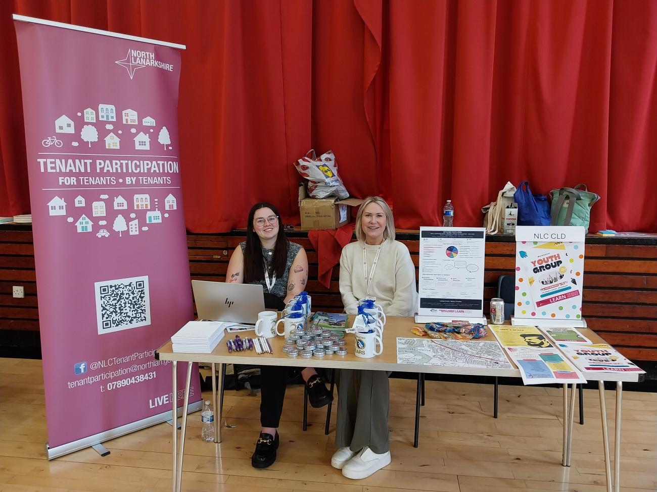 adults sitting around table with promotional materials