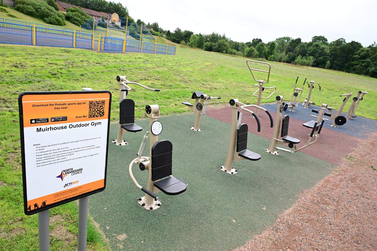 greenspace with outdoor gym equipment on safety surface