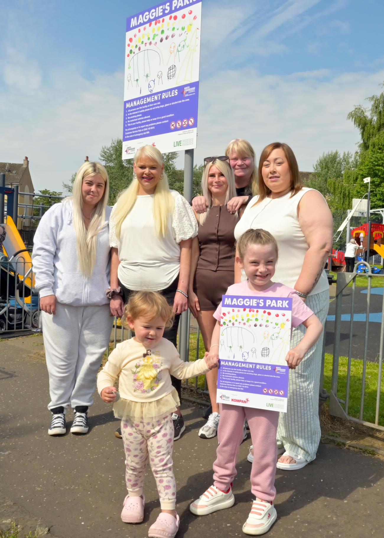 children and adults with new sign for play area