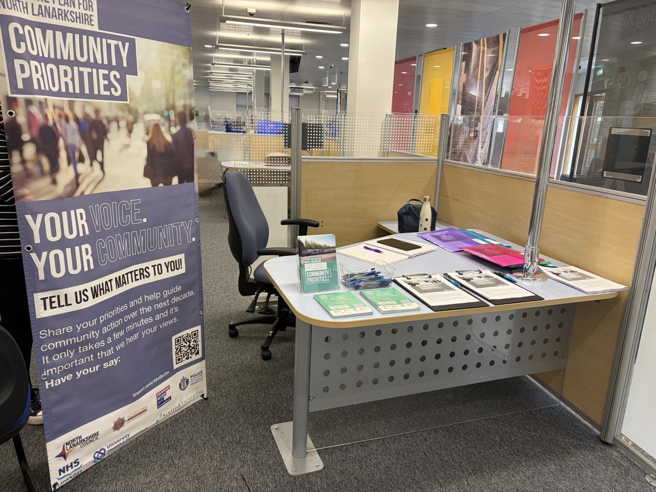 desk and chair with pop up banner and leaflets