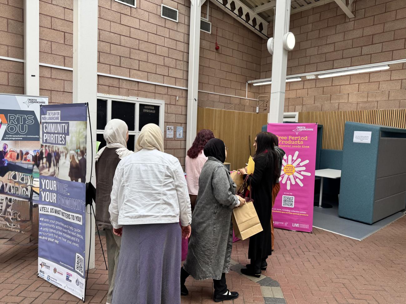 people taking free period products from table